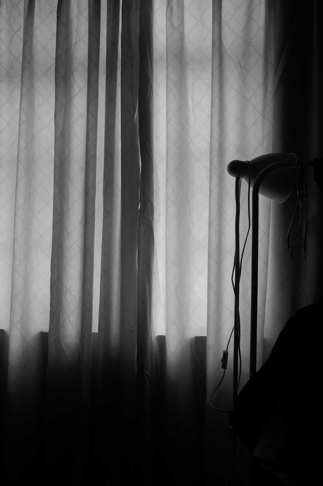 Backstage curtain and a microphone waiting on a dimly lit stage