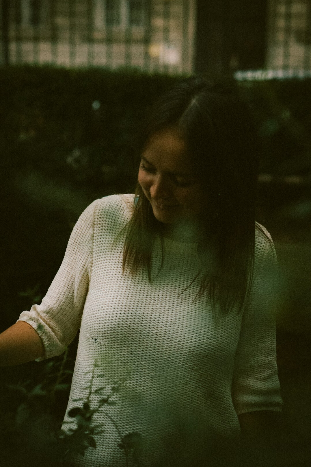 Portrait of a smiling woman in her thirties with dark hair wearing a light sweater